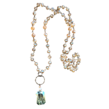 This chain and bead mixed necklace has bronze links and taupe blush translucent bead. It has a blue translucent pendant attached by a jump ring. This is one continuous strand with no lobster claw clasp. This can be worn long or short, by attaching the small hook to the jump ring for a double-layer look.

Length of beaded chain (not including jump ring and dangle pendant): 18" Length from top to bottom of pendant: Approx 20.5" Pendant :1" L 1/2 W Jump ring : 1"
