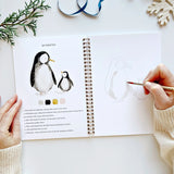 The Winter Watercolor Workbook includes 12 winter-themed illustrations with an example of the finished painting, step-by-step instructions, and a lightly illustrated sketch for you to paint. It's just like a coloring book, but with watercolor! Enjoy this peaceful painting hobby on your own, with children, or with friends. Makes a wonderful gift and is perfect for artists of any age.

12 beginner-friendly illustrations on thick 120lb watercolor paper

Lay-flat pages with spiral binding for hassle-free painti