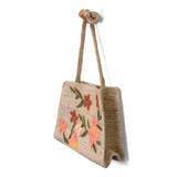 Lovely hand embroidered flowers in multiple colors of pink, peach and green adorn this sweet crossbody style crafted in all-natural jute. Just the right size to stow a large wallet, phone and more. This bag will look perfect with your sundress or shorts this summer!

Dimensions: 10.5 in. H x 11.5 in. W x 4 in. D
Magnetic snap closure
Shoulder strap: 21 in. drop
Brass plated hardware
100% Natural Jute with embroidered flowers
Unlined
