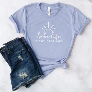 Our "Lake Life Is The Best Life" will be your favorite t-shirt this summer! It is a beautiful light blue color with "Lake life is the best life" written in a white mixed font with a sun with rays shining above. 