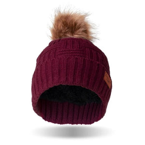 Stay warm and fashionable with our Britt Knits wine-colored cable knit hat with a tan and brown faux fur pom. The inside is ultra-cushy and velvety, so you'll never want to take it off!! It can be worn fitted or slouched with a subtle braided design to match any style coat, jacket, or tee.