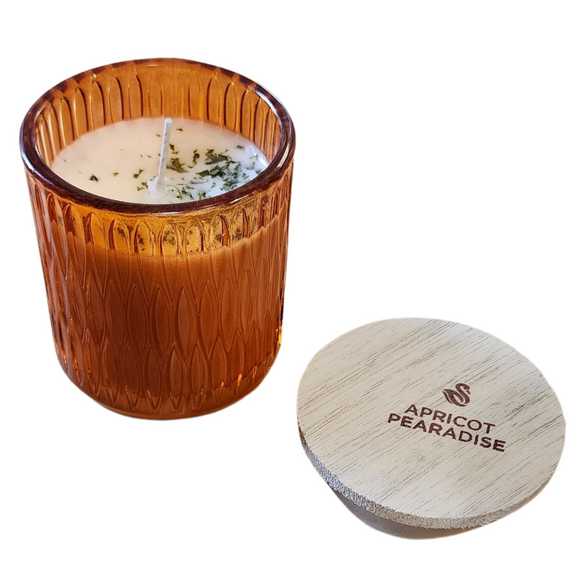 You'll love our newest cathedral glass tumbler! This apricot pearadise candle has been poured into a pretty orange patterned glass and comes with a wooden lid.

Transport your home to a fruity pear-a-dise! Tart, white apricot, and juicy pear blend with coconut milk, peach nectar, and vanilla extract for an over-the-top, luscious fruit concoction. Hints of sugared caramel and sweet musk balance the blend and tie it all together.

Scent Profile: Top: White Apricot, Peach Nectar, Crisp Pear Middle: Whipped Cre