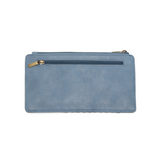 This slim and sleek wallet has nine credit card pockets, each with a snap tab for security and brass-plated hardware. It also has an ID window, zippered change pocket, and zippered billfold pocket in distressed bluebird skies vegan leather.


DIMENSIONS: 3.75 IN. H X 7.25 IN. W X .25 IN. D&nbsp;


100% Vegan leather (polyurethane)