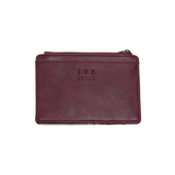 We love this mini wallet in a blackberry colored vegan leather! It is full of style and will hold your license and up to six credit cards. The zipper pocket is roomy enough for your change and cash, and a pocket is on the back.&nbsp; This mini wallet is perfect for you, but it makes an awesome gift!

DIMENSIONS: 4 IN. H X 5.5 IN. W X .25 IN. D

ZIPPERED TOP CLOSURE ON EDGE

6 CREDIT CARD POCKETS

ID WINDOW POCKET

EXTERIOR PASSPORT POCKET

STRIPED LINING

BRASS PLATED HARDWARE

100% VEGAN LEATHER (POLYURETH