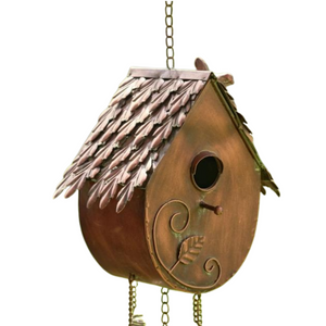 Bring some charm to your outdoor space with our birdhouse chimes! It is beautifully handpainted with a distressed antique copper finish. The house is pear-shaped with a pretty shingle-like roof. There is a bird perched on the top right-hand side. A birdhole in the front lets birds go in (the house has drainage holes at the bottom). 