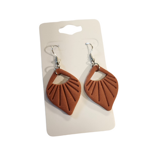 You will love these lightweight, trendy polymer clay earrings with a beautiful shell pattern! This pair of clay earrings is coated with a resin layer to give them a pretty shine and finished look! The earring hooks are comfortable and easy to wear and made of high-quality, strong/durable stainless steel, which is hypoallergenic and nickel-free. *&nbsp;

This versatile earring design would accompany any outfit, from casual to dressed up!&nbsp;

Handcrafted in Texas, USA&nbsp;

CARE INSTRUCTIONS FOR EARRINGS 