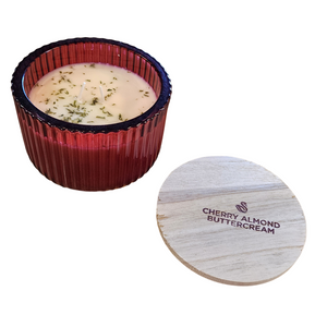 You'll love our new cathedral bowl candle style and size! This cherry almond buttercream candle has been poured into a pretty red-patterned glass and comes with a wooden lid.

Dark, sweet cherries, roasted Italian almonds and whipped fresh buttercream are layered with hints of black plum and mandarin - warm and juicy yet smooth!

Filled with 6.5 oz. of American Soybean WaxTM. Measures 4.25"W x 3.25 "H (with lid) with a 40+ hour burn time