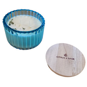 You'll love our new cathedral bowl candle style and size! This citrus &amp; sage candle has been poured into a pretty blue-patterned glass and comes with a wooden lid.

An upfront Sage note followed by a blend of citrus that is certain to be enjoyed!

Filled with 6.5 oz. of American Soybean WaxTM. Measures 4.25"W x 3.25 "H (with lid) with a 40+ hour burn time