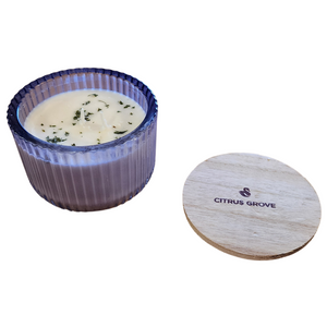 You'll love our new cathedral bowl candle style and size! This citrus grove candle has been poured into a pretty purple-patterned glass and comes with a wooden lid.

Vibrant nuances of Tangerine, Mandarin &amp; Cassis shine on top. Traces of Red Currants, Guava, and Lemon Flower sweet throughout. Bottom notes of green Ivy &amp; Lily add to Vanilla Sugar for the finishing touches.

Filled with 6.5 oz. of American Soybean WaxTM. Measures 4.25"W x 3.25 "H (with lid) with a 40+ hour burn time