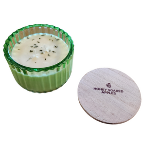 You'll love our new cathedral bowl candle style and size! This honey soaked apples candle has been poured into a pretty green-patterned glass and comes with wooden lid.

Pure, Crisp and Refreshing. Mild honey notes with a pure, crisp apple body for a high throw.

Filled with 6.5 oz. of American Soybean WaxTM. Measures 4.25"W x 3.25 "H (with lid) with a 40+ hour burn time
