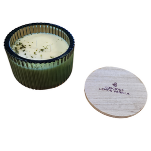 You'll love our new cathedral bowl candle style and size! This luscious lemon vanilla candle has been poured into a pretty dark green-patterned glass and comes with a wooden lid.

Vibrant nuances of Tangerine, Mandarin &amp; Cassis shine on top. Traces of Red Currants, Guava, and Lemon Flower sweet throughout. Bottom notes of green Ivy &amp; Lily add to Vanilla Sugar for the finishing touches.

Filled with 6.5 oz. of American Soybean WaxTM. Measures 4.25"W x 3.25 "H (with lid) with a 40+ hour burn time
