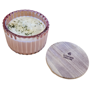You'll love our new cathedral bowl candle style and size! This summer melon candle has been poured into a pretty pink-patterned glass and comes with a wooden lid.

Honeydew and watermelon both come together to create this refreshing summery fragrance!

Filled with 6.5 oz. of American Soybean WaxTM. Measures 4.25"W x 3.25 "H (with lid) with a 40+ hour burn time