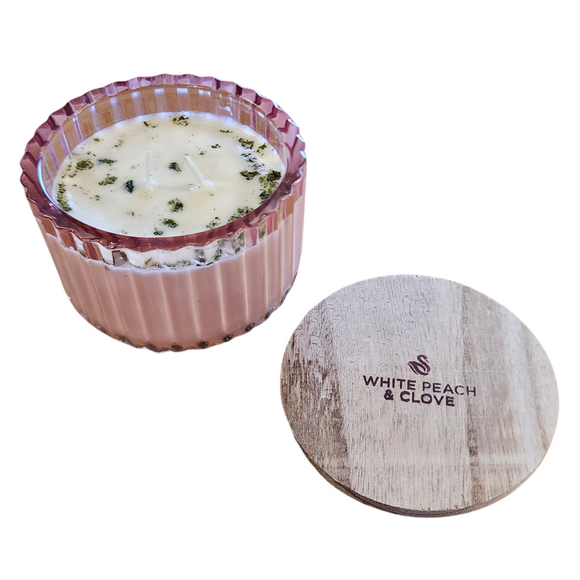 ou'll love our new cathedral bowl candle style and size! This white peach & clove candle has been poured into a pretty pink-patterned glass and comes with a lid.

Rich and high throws of peach and a mild clove note are definitely one of our favorites.

Filled with 6.5 oz. of American Soybean WaxTM. Measures 4.25