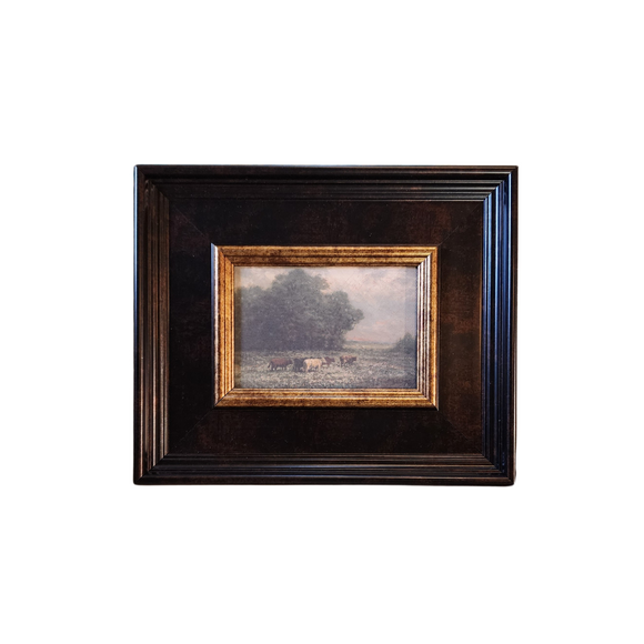 We are in love with this chunky frame with a small print of cattle crazing in a meadow! We know that you'll find lots of places to put this little artwork! Printed on premium canvas fabric for a lasting, textured finish and has a handcrafted ornate bronze and gold frame that adds a classic charm.  Comes with a paper backing and hanging hardware for easy installation.

Made in the USA: Proudly crafted with quality and care. 

Care Instructions: Keep canvas dry to maintain its quality. If smudged or