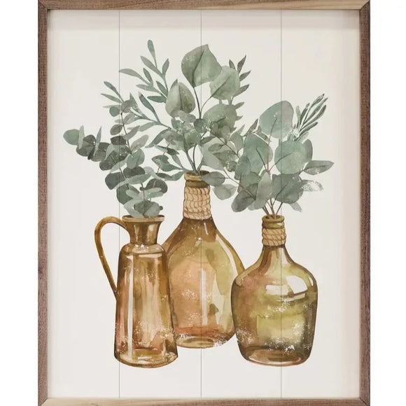 If you need a room refresh, this picture may help you! Three brown glass vases are in the center of this picture. All three have different greens sticking out of them.   This unique piece is a simple way to bring beauty and charm to any wall or shelf within the home. It is made from high-quality American hardwood planks with a hand-painted face, printed with UV-cured ink, and is framed in a natural walnut frame.