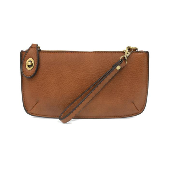 Our most popular bag, this mini clutch, with its sleek silhouette, is as gorgeous as it is versatile.  Features include a polished turn lock, six card slots, and an interior zipper for change.  It can be styled in many ways, with removable straps to alternate between wallet, crossbody, and wristlet!   5