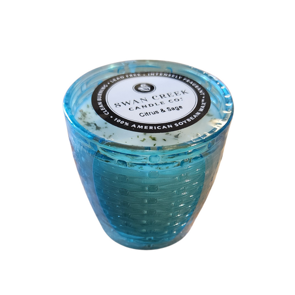 You'll love our cathedral small vase candle. This citrus & sage candle has been poured into a pretty basketweave blue glass.

Vibrant nuances of Tangerine, Mandarin & Cassis shine on top. Traces of Red Currants, Guava, and Lemon Flower sweet throughout. Bottom notes of green Ivy & Lily add to Vanilla Sugar for the finishing touches.


Filled with 4.5 oz. of American Soybean WaxTM. Measures 3