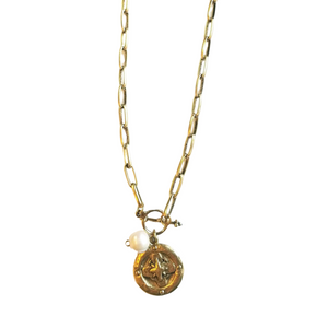 This combines a beautiful artisan compass gold pendant with an elegant, yet substantial gold-linked artisan chain. Accented with a shell pearl this necklace will always be a reminder to find your way home.&nbsp;

16" long