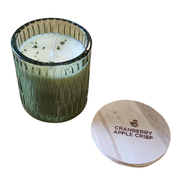 You'll love our newest cathedral glass tumbler! This cranberry apple crisp has been poured into a pretty green patterned glass and comes with a wooden lid.

New England rich cranberries are combined with tart apple cider and hints of cinnamon make this a year round favorite.

Filled with 6.5 oz. of American Soybean WaxTM. Measures 3.25