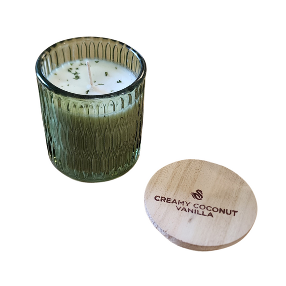 You'll love our newest cathedral glass tumbler! This creamy coconut vanilla has been poured into a pretty green patterned glass and comes with a wooden lid.

Reminiscing about lazy, summer days spent on the water? This fragrance immediately captures the essence of summer with a base of creamy coconut flakes, sugared vanilla, and hints of caramelized amber. Swirls of bright tangerine and suntan lotion play peek-a-boo through the blend reminding one of a bygone era where life was as simple as getting a summer