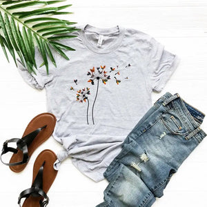 This is a super fun tee for the chicken lover! This heathered grey tee has two dandelions on the front with lots of little chickens that are used as the seeds floating off - what a hoot!&nbsp; The shirts are soft Bella and Canvas unisex fashion-fit tees that fit like a well-loved favorite, featuring a crew neck and short sleeves.

100% Airlume combed and ring-spun cotton.

Made in the United States