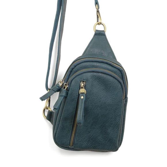 Blending uptown chic with downtown cool, the Skyler sling bag is made in rich dark teal colored vegan leather! A convertible strap lends versatility, while a front zip pocket offers practical storage for your necessities. It is the perfect companion for a night out on the town or a fun day trip!   8