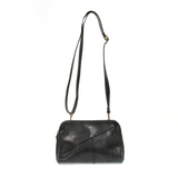 Retro styling crafted in antiqued vegan leather gives this black-colored clutch a vintage vibe. The removable woven wrist strap is the finishing touch on this stylish bag so you can wear it as a wristlet, clutch, or crossbody with the included removable shoulder strap!   6.75"H x 9.75"W x 2.25"D