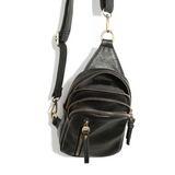 Blending uptown chic with downtown cool, the Skyler sling bag is made in rich vegan black leather! A convertible strap lends versatility, while a front zip pocket offers practical storage for your necessities. It is the perfect companion for a night out on the town or a fun day trip!  8" h x 5.5" w  x 2.25" d