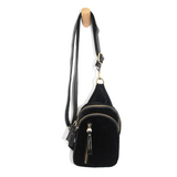 Blending uptown chic with downtown cool, the Skyler sling bag is made in beautiful black velvet! A convertible strap lends versatility, while a front zip pocket offers practical storage for your necessities. It is the perfect companion for a night out on the town or a fun day trip!  8" h x 5.5" w  x 2.25" d