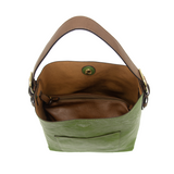 Equally timeless and modern, our best-selling classic hobo is made in rich vegan leather in a forever green color, accented with a coffee-colored brown strap.  This roomy bag, accented with a large front pocket and a snap-in removable brown crossbody, has plenty of room to carry your needs in style.