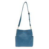Casual and carefree crossbody in super soft pebble grain vegan leather! Our Kayleigh bucket bag in a beautiful peacock blue color comes with a smaller bag in the same color that can be carried inside or used alone! The convenient side pockets of this bucket bag can carry your water bottle, phone, or glasses.  11" W X 11.25" H X 3.5"