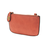 Our most popular bag, in a vibrant desert coral color! With its sleek silhouette, this mini clutch is as gorgeous as it is versatile.  Features include a polished turn lock, six card slots, and an interior zipper for change.  It can be styled in many ways, with removable straps for alternating between wallet, crossbody, and wristlet!   5"H x 9.5"W x 1"D  Removable and adjustable crossbody strap 13"-24"  Wristlet strap 7" long