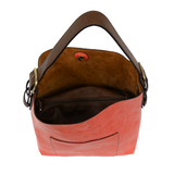 Equally timeless and modern, our best-selling classic hobo is made in rich vegan leather in a beautiful hot coral color, accented with a coffee brown strap.  This roomy bag, accented with a large front pocket and a snap-in removable brown crossbody, has plenty of room to carry your needs in style. MAIN BAG 12" h x 14" w x 6" d  Adjustable strap 6"-11"  Magnetic snap top closure  Exterior open pocket