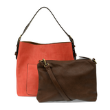 Equally timeless and modern, our best-selling classic hobo is made in rich vegan leather in a beautiful hot coral color, accented with a coffee brown strap.  This roomy bag, accented with a large front pocket and a snap-in removable brown crossbody, has plenty of room to carry your needs in style. MAIN BAG 12" h x 14" w x 6" d  Adjustable strap 6"-11"  Magnetic snap top closure  Exterior open pocket