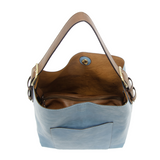 Equally timeless and modern, our best-selling classic hobo is made in rich vegan leather in a beautiful tranquil blue color, accented with a coffee brown strap.  This roomy bag, accented with a large front pocket and a snap-in removable brown crossbody, has plenty of room to carry your needs in style. MAIN BAG 12" h x 14" w x 6" d  Adjustable strap 6"-11"  Magnetic snap top closure