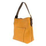 Equally timeless and modern, our best-selling classic hobo is made in rich vegan leather in&nbsp;a beautiful&nbsp;deep berry color,&nbsp;accented with a brown strap.&nbsp; This roomy bag, accented with a large front pocket and a snap-in removable brown crossbody, has plenty of room to carry your needs in style.   MAIN BAG  12" h x 14" w x 6" d