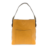 Equally timeless and modern, our best-selling classic hobo is made in rich vegan leather in&nbsp;a beautiful&nbsp;deep berry color,&nbsp;accented with a brown strap.&nbsp; This roomy bag, accented with a large front pocket and a snap-in removable brown crossbody, has plenty of room to carry your needs in style.   MAIN BAG  12" h x 14" w x 6" d