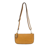 Our most popular bag, in a honey gold color, this mini clutch, with its sleek silhouette, is as gorgeous as it is versatile.  Features include a polished turn lock, six card slots, and an interior zipper for change.  It can be styled in many ways, with removable straps for alternating between wallet, crossbody and wristlet!   5"H x 9.5"W x 1"D  Removable and adjustable crossbody strap 13"-24"  Wristlet strap 7" long  interior zippered pocket  brass plated hardware  100% vegan leather (polyurethane)