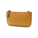 Our most popular bag, in a honey gold color, this mini clutch, with its sleek silhouette, is as gorgeous as it is versatile.  Features include a polished turn lock, six card slots, and an interior zipper for change.  It can be styled in many ways, with removable straps for alternating between wallet, crossbody and wristlet!   5"H x 9.5"W x 1"D  Removable and adjustable crossbody strap 13"-24"  Wristlet strap 7" long  interior zippered pocket  brass plated hardware  100% vegan leather (polyurethane)
