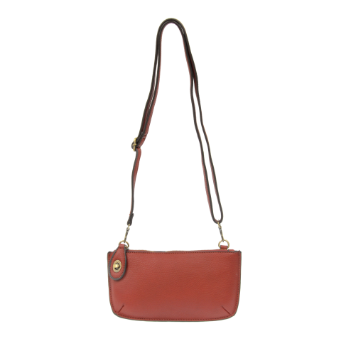 Our most popular bag, in a rich garnet color, this mini clutch, with its sleek silhouette, is as gorgeous as it is versatile.  Features include a polished turn lock, six card slots, and an interior zipper for change.  It can be styled in many ways, with removable straps for alternating between wallet, crossbody, and wristlet!   5