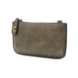 Our most popular bag, in metallic dark chrome color, this mini clutch, with its sleek silhouette, is as gorgeous as it is versatile.  Features include a polished turn lock, six card slots, and an interior zipper for change.  It can be styled in many ways, with removable straps for alternating between wallet, crossbody, and wristlet!   5"H x 9.5"W x 1"D  Removable and adjustable crossbody strap 13"-24"  Wristlet strap 7" long  interior zippered pocket  brass plated hardware  100% vegan leather (polyurethane)
