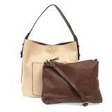 Equally timeless and modern, our best-selling classic hobo is made in rich vegan leather in a beautiful cream color, accented with a coffee brown strap.  This roomy bag, accented with a large front pocket and a snap-in removable brown crossbody, has plenty of room to carry your needs in style.