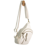 Blending uptown chic with downtown cool, the Skyler sling bag is made in beautiful vegan white-colored leather! A convertible strap lends versatility, while a front zip pocket offers practical storage for your necessities. It is the perfect companion for a night out on the town or a fun day trip!  8" h x 5.5" w  x 2.25" d