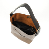 Equally timeless and modern, our best-selling classic hobo is made in rich vegan leather in mushroom accented with a black strap.  This roomy bag, accented with a large front pocket and a snap-in removable crossbody, has plenty of room to carry your needs in style