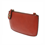 Our most popular bag, in a vibrant cherry red! With its sleek silhouette, this mini clutch is as gorgeous as it is versatile.  Features include a polished turn lock, six card slots, and an interior zipper for change.  It can be styled in many ways, with removable straps for alternating between wallet, crossbody, and wristlet!   5"H x 9.5"W x 1"D