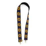 Do you want to SPARK a little STYLE this season?  Add a fun new guitar strap to your purse!  This 2" strap is full of character with its stunning mustard yellow daisies and royal blue and burgundy leaves in between each flower, all on a black strap. The back of the strap is a solid black. 2" wide  Adjustable 35-54" in length  Embroidered cotton   Antique brass hardware