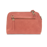 Retro styling crafted in antiqued vegan leather gives this bright coral colored clutch a vintage vibe. The removable woven wrist strap is the finishing touch on this stylish bag, so you can wear as a wristlet, a clutch, or even a crossbody with the included removable shoulder strap!   6.75"H x 9.75"W x 2.25"D  Removable and adjustable crossbody strap 22"-26"  Removable long wristlet strap 7.5" long  Zippered top closure
