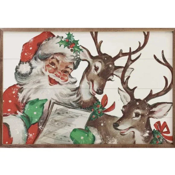 Ho Ho Ho! We are smitten with our vintage-inspired art this year!  This Santa is going through his list with two of his reindeer. You'll certainly bring on the nostalgia!  It is made from high-quality American hardwood planks with a hand-painted face, printed with UV-cured ink, and framed in a natural walnut frame. Each piece is unique with its own personality, marks, wood grain, and look. Easy to clean with a dry cloth.  Made in the USA  8