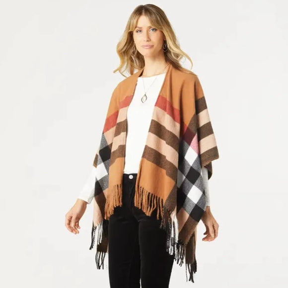 Slay your fall wardrobe this season with this cognac plaid ruana with black, cream, and red plaid accents. With its pops of fringe along the edges, it will be your perfect layering piece for fall.  We love that it has a tacked sleeve so it stays on your shoulders. It’s one size fits most and is perfect for chilly days, so snuggle up and stay comfortable. Get ready to turn heads in this must-have piece!