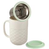 This 15oz Weave tea infuser mug is made from new bone china and has a green silicone top. The exterior of the tea infuser mug features a weave-textured design. The top part of the mug where you drink is a smooth finish. The mug's interior is white, allowing you to see the color of the tea. The mug includes a stainless steel filter for loose-leaf tea and tea bags. The mug has a comfortable handle and a nice weight and feel. It is not too heavy. The handle does not get hot in the microwave.